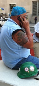 a man with tattooed arms and a dew rag on his head
